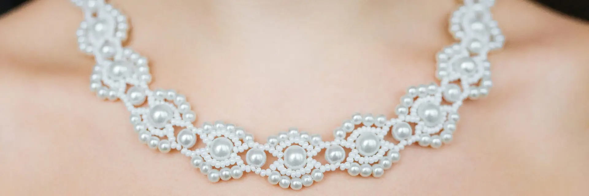 Jewelry concept. Closeup portrait of a wedding necklace on female neck